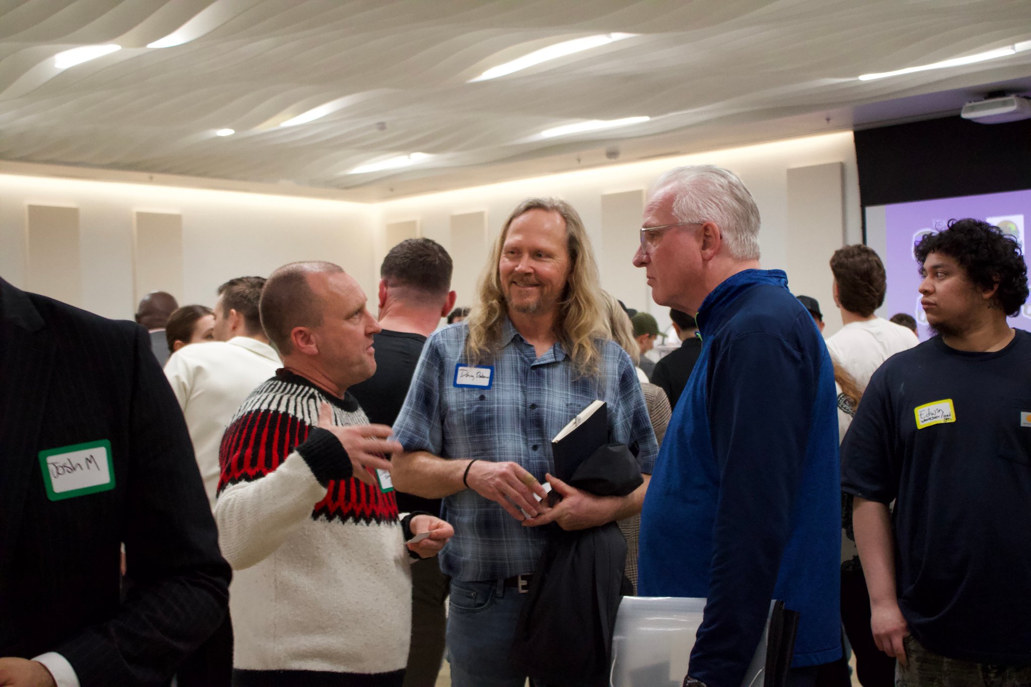 NorCal REIA investors networking and exchanging contact information at an event